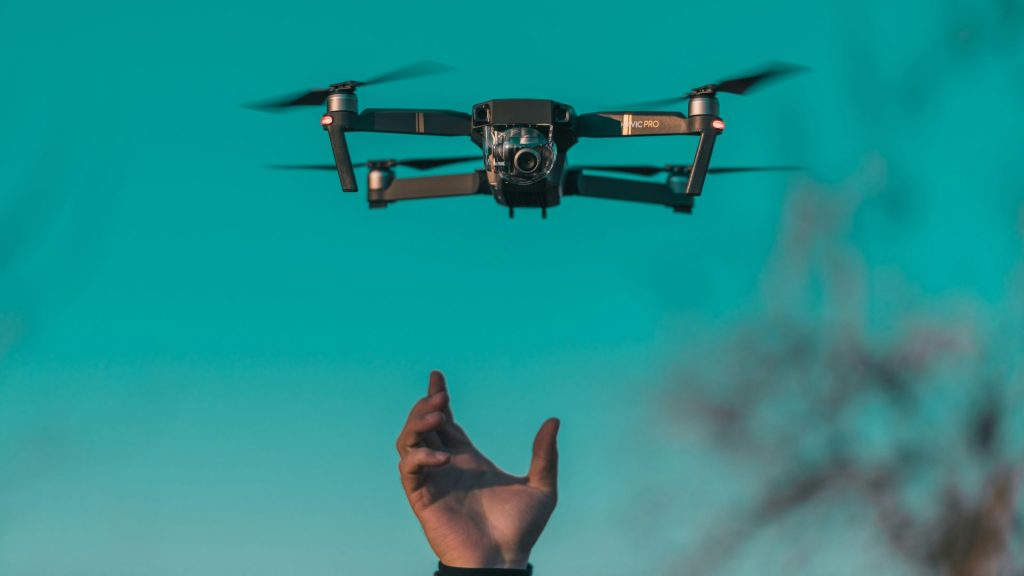 A drone flying over the landscape at sunset.