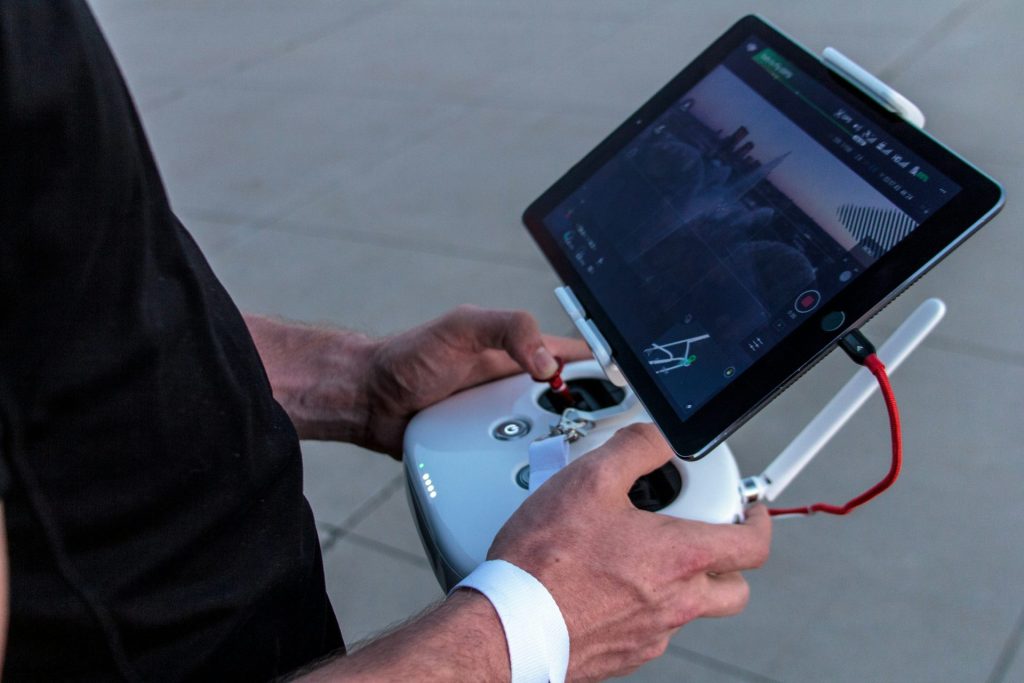 Person controlling drone with tablet device.
