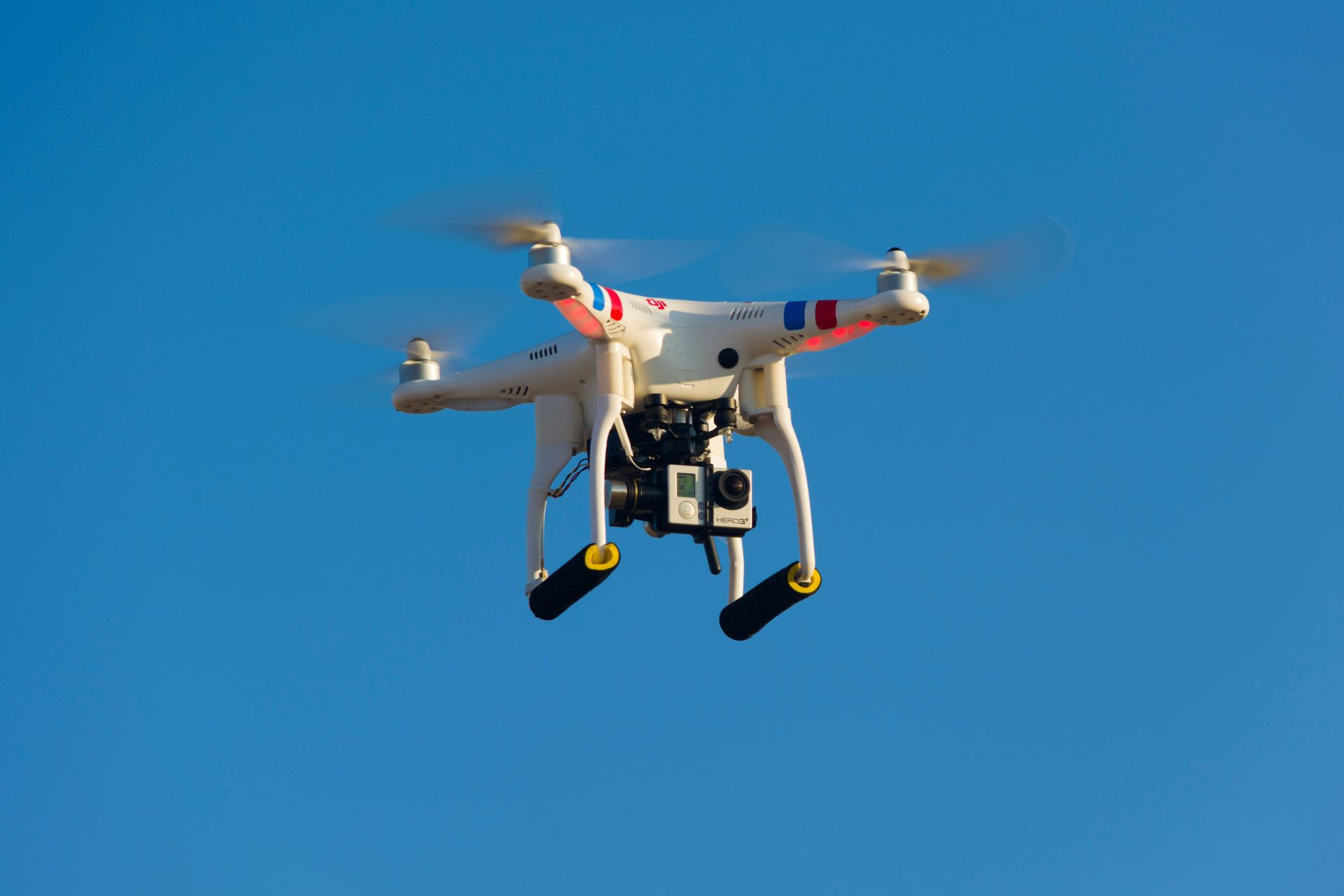A drone flying in a clear sky.