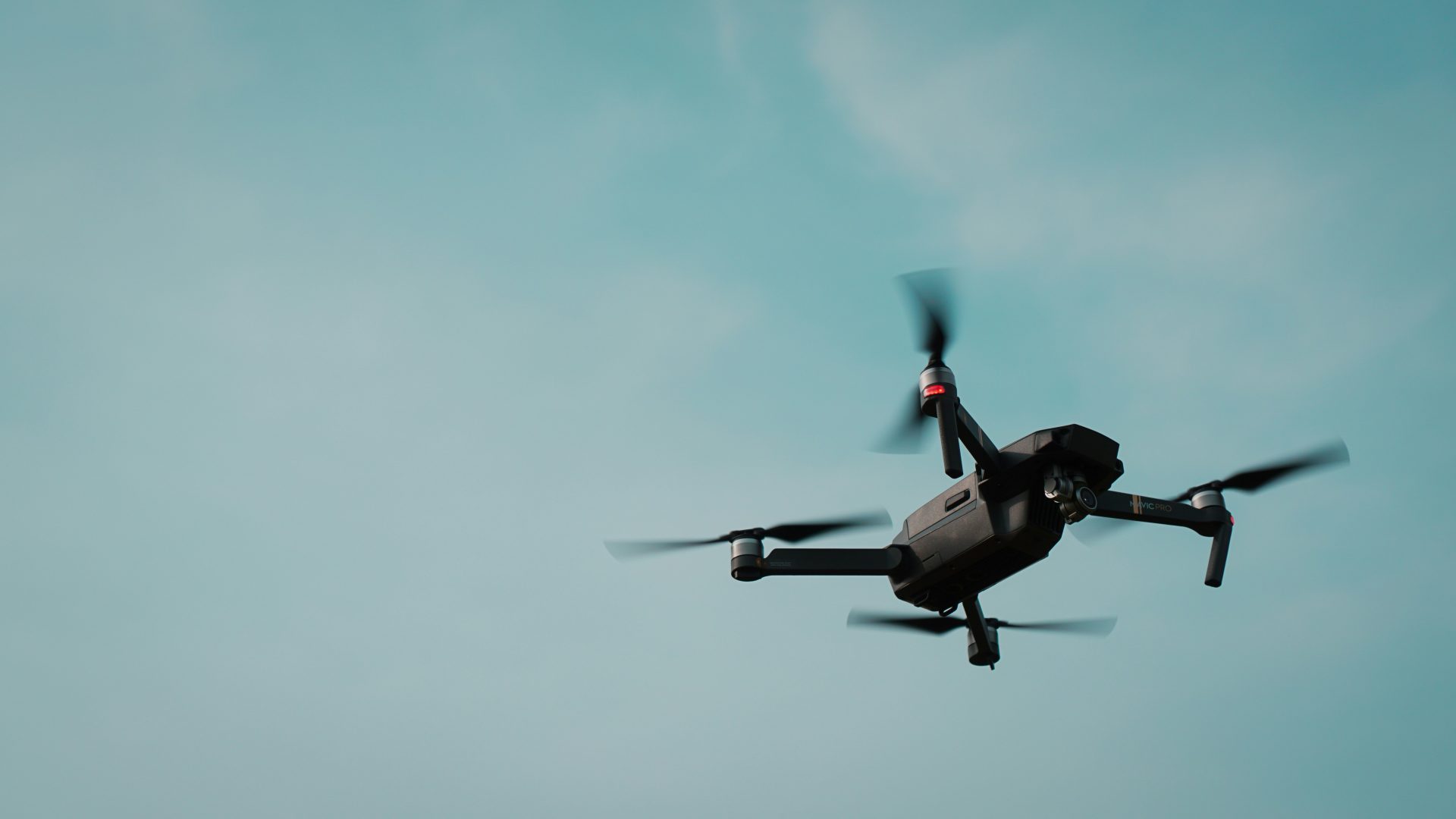 Drone flying above scenic mountain landscape.