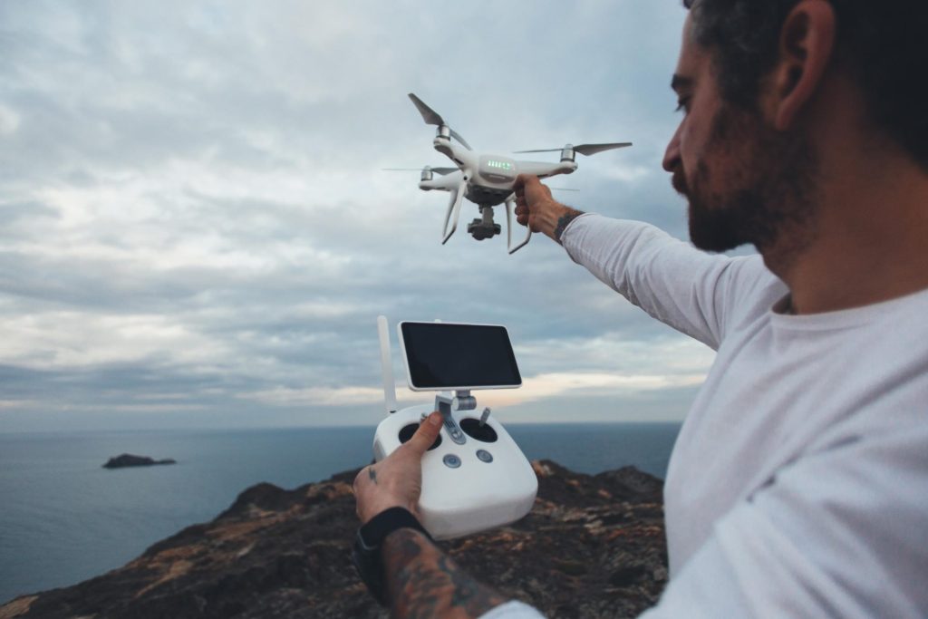 Person releasing drone into the air.