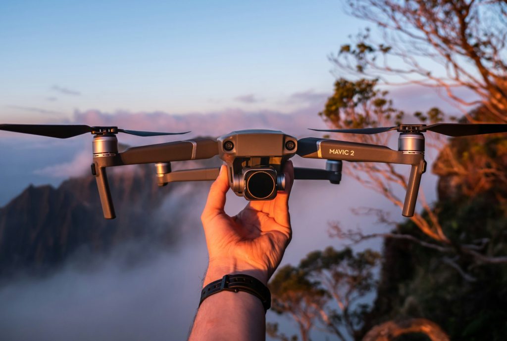 Person preparing to fly drone outdoors.